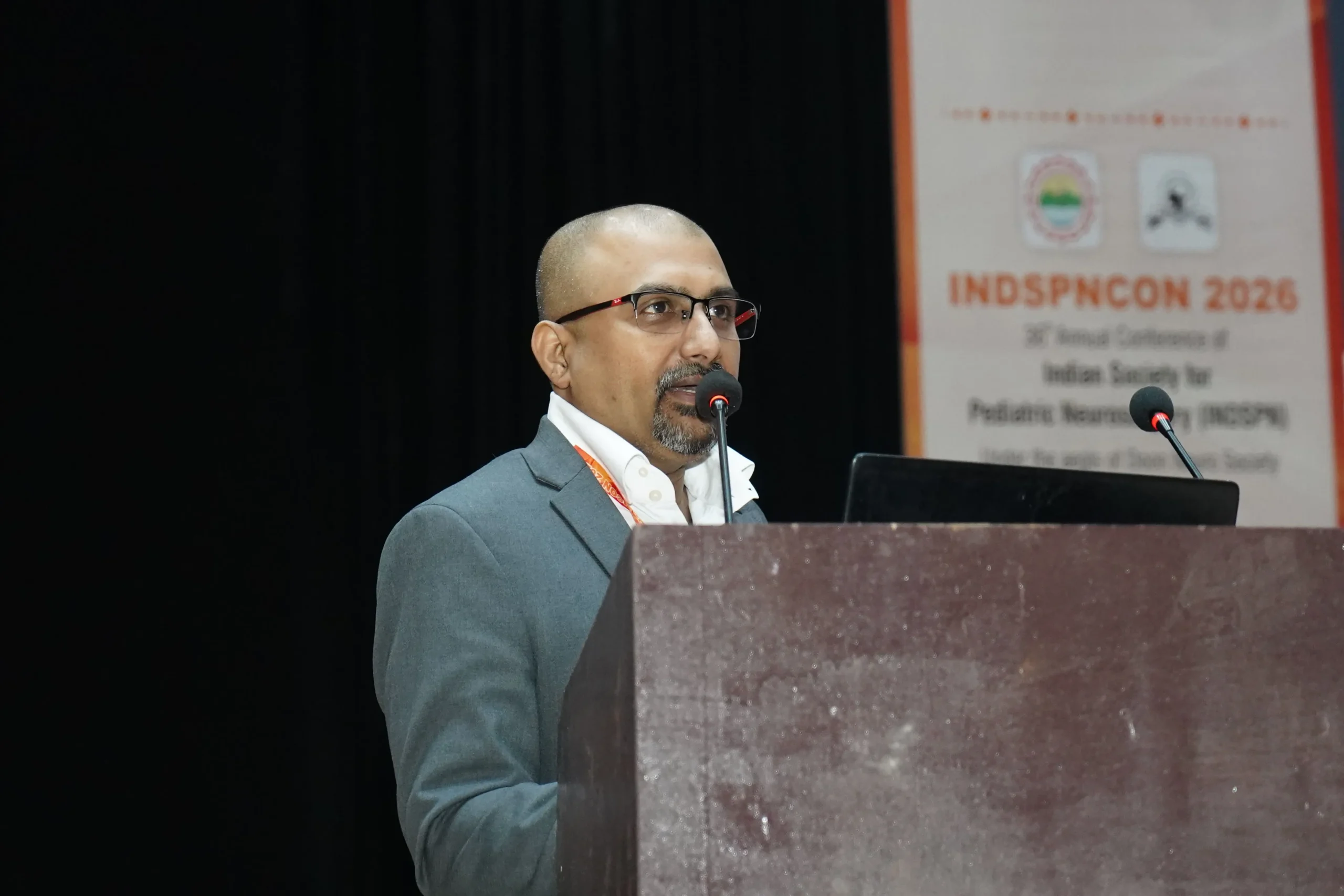 Dr Mohana Rao Patibandla speaking at INDSPNCON 2026 about advanced pediatric neurosurgery techniques including minimally invasive brain surgery and neuro-navigation at Dr Rao’s International Institute of Neurosciences