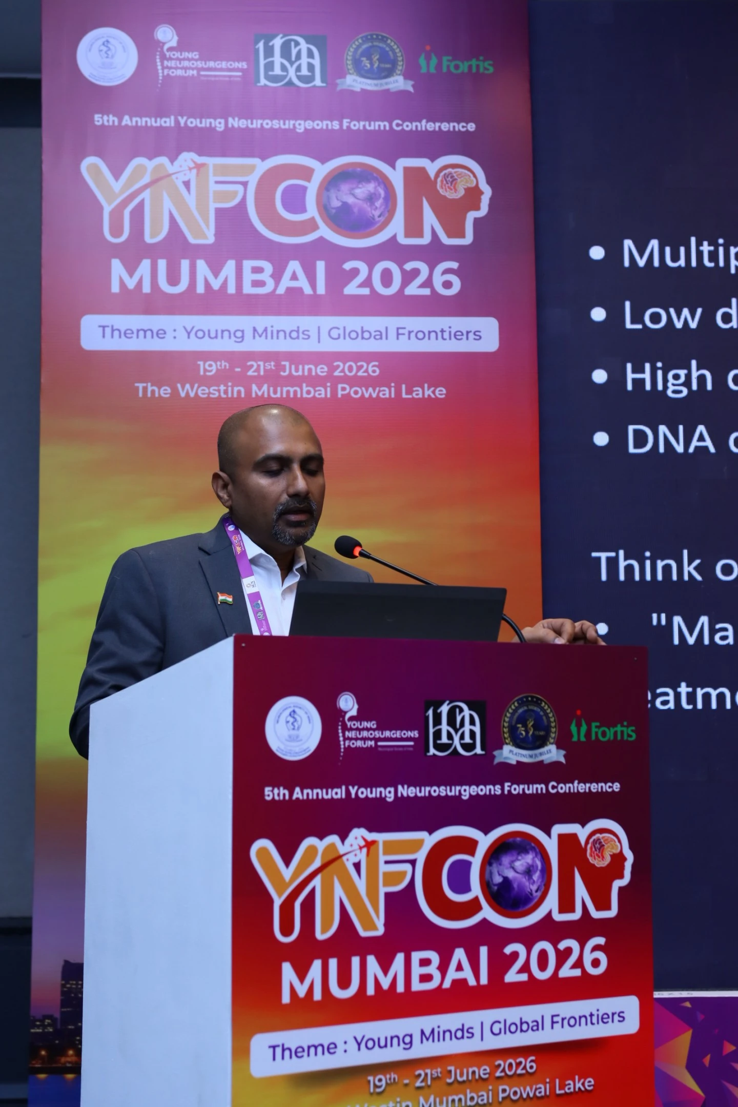 Dr. Mohana Rao Patibandla delivering a lecture on stereotactic radiosurgery at YNFCON 2026 Mumbai, discussing advanced minimally invasive neurosurgical treatment techniques for young neurosurgeons.